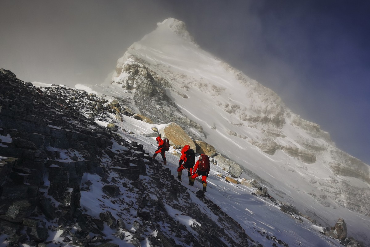 FILE - In this May 27, 2020, file photo released by Xinhua News Agency, members of a Chinese surveying team head for the summit of Mount Everest, also known locally as Mt. Qomolangma. China and Nepal  ...