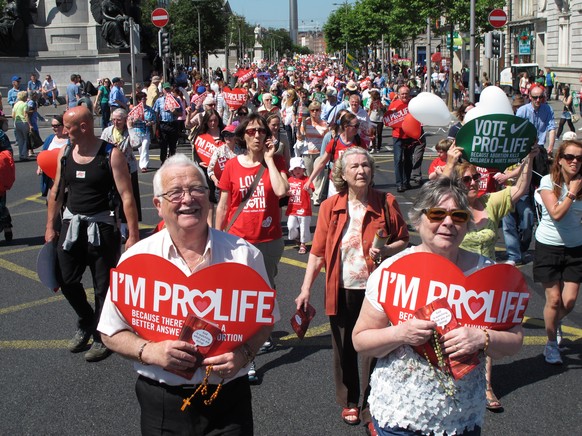 FILE - A Saturday, July 6, 2013 file photo showing Stephen and Pauline O&#039;Brien, foreground, holding Catholic rosary beads as they march through Ireland&#039;s capital, Dublin, in an anti-abortion ...