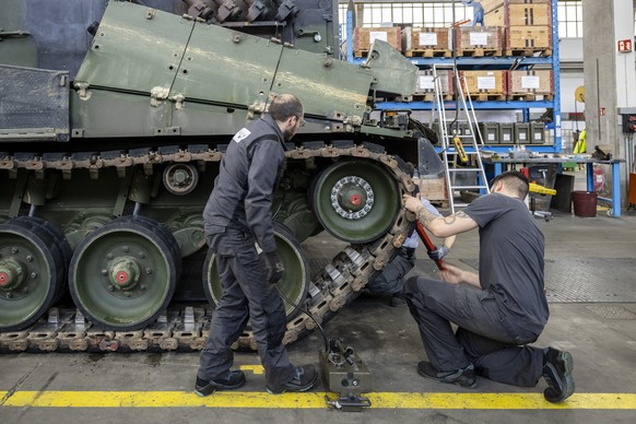 Mechaniker warten die Raupen an einem Panzer vom Typ Leopard 2 in einer Wartungshalle der RUAG, am Montag, 20. Maerz 2023, in Thun. (KEYSTONE/Peter Schneider)