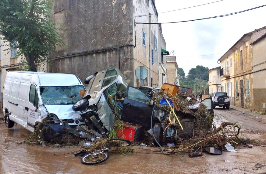 epa07082866 View of several vehicles destroyed after a flash flood hit the village of Sant Llorenc des Cardasar, in Mallorca island, eastern Spain, 10 October 2018. At least six people died and severa ...