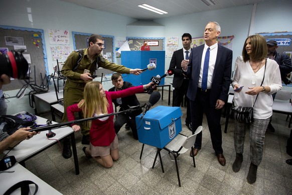 Blue and White party leader Benny Gantz, right, casts his vote with his wife Revital Gantz left, and former Israeli Chief of Staff Benny Gantz during Israel&#039;s parliamentary elections in Rosh Haay ...