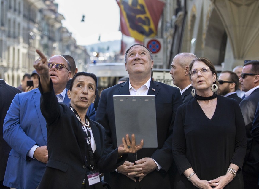 epa07617078 US Secretary of State Mike Pompeo (C), his wife Susan Pompeo (R) and US Ambassador to Switzerland, Edward T. McMullen (L) listen to a tourist guide during a walk through the old town of Be ...