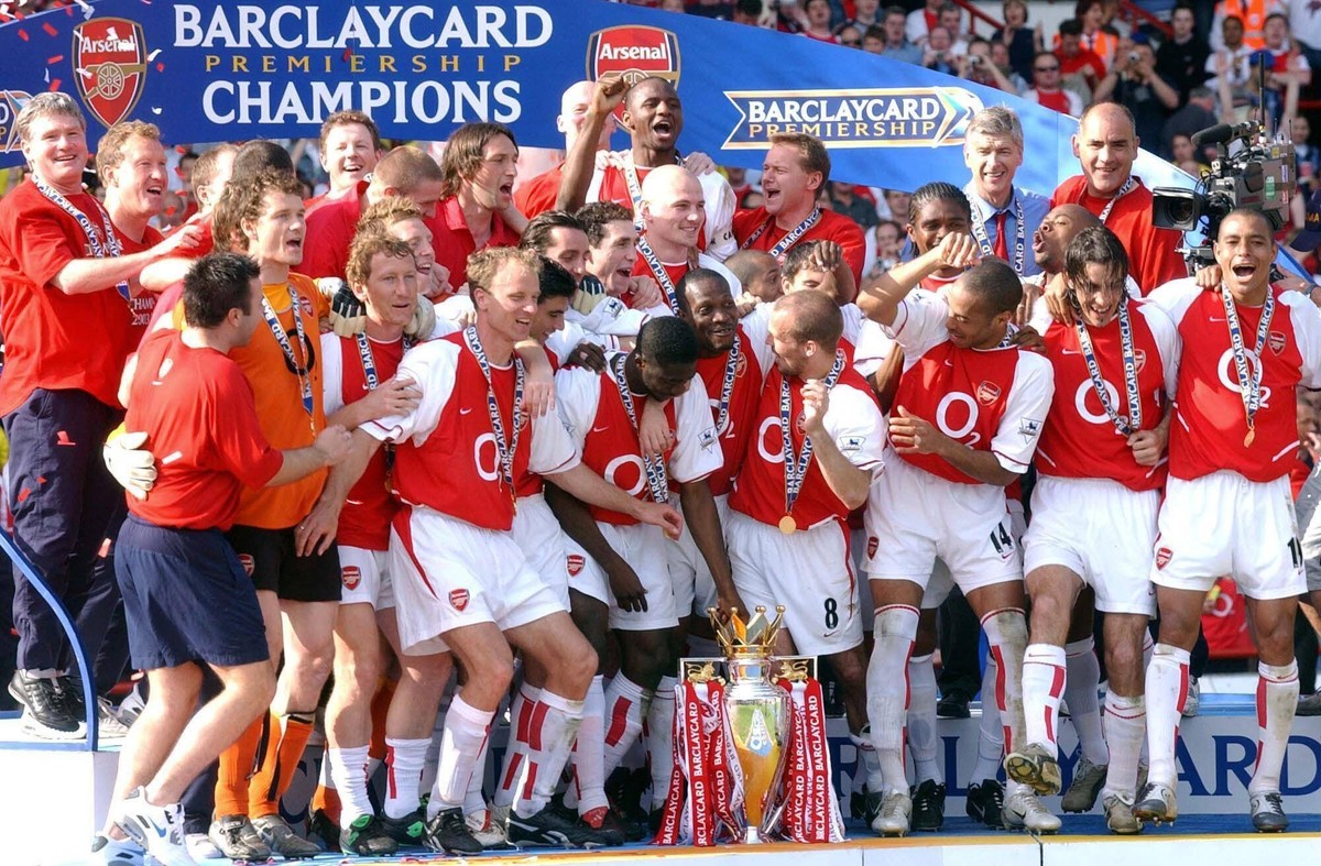 Liverpool win the Premier League package File photo dated 15-05-2004 of Arsenal players celebrate with the Barclaycard Premiership trophy after their match against Leicester City at Arsenal s Highbury ...