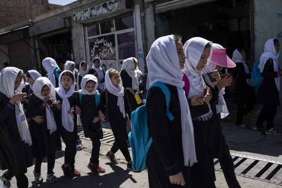 FILE - Students walk together from school in Kabul, Afghanistan, Wednesday, June 7, 2023. Afghanistan?s schools open Wednesday for the new educational year, while thousands of schoolgirls remain barre ...