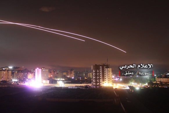 epa06724730 A handout photo made available by government-affiliated Syrian Military Media is said to show Syrian air defense missiles intercepting missile strikes over Damascus, Syria, 09 May 2018 (is ...