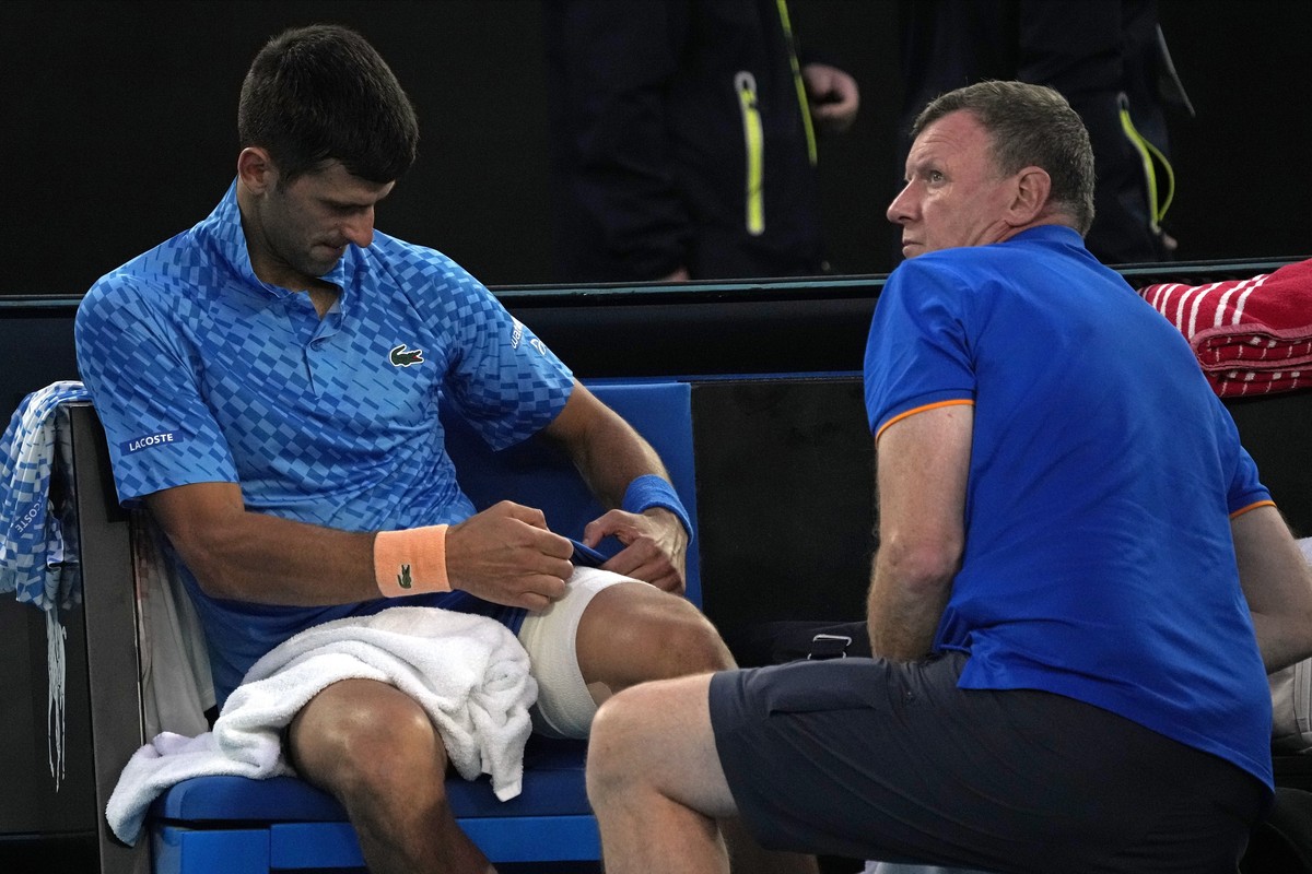 Novak Djokovic of Serbia receives treatment to a leg injury during his third round match against Grigor Dimitrov of Bulgaria at the Australian Open tennis championship in Melbourne, Australia, Saturda ...