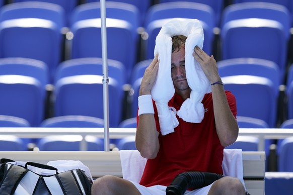 Daniil Medvedev, of the Russian Olympic Committee, cools off during a changeover in a tennis match against Alexander Bublik, of Kazakhstan, during at the 2020 Summer Olympics, Saturday, July 24, 2021, ...