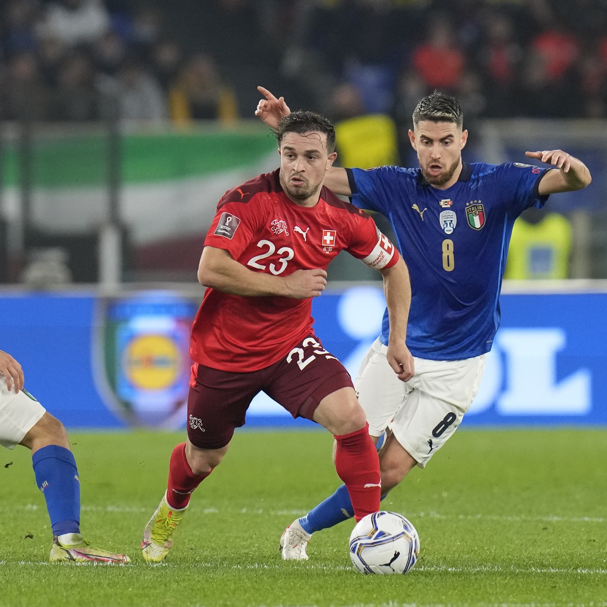 Switzerland's Xherdan Shaqiri, center, is challenged by Italy's Nicola Barella, left, and Italy's Jorginho during the World Cup 2022 group C qualifying soccer match between Italy and Sw ...