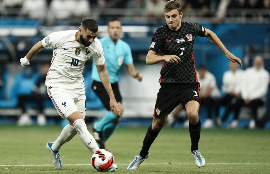 France&#039;s Karim Benzema, left, duels for the ball with Croatia&#039;s Josip Stanisic during the UEFA Nations League soccer match between France and Croatia at the Stade de France in Saint Denis ne ...