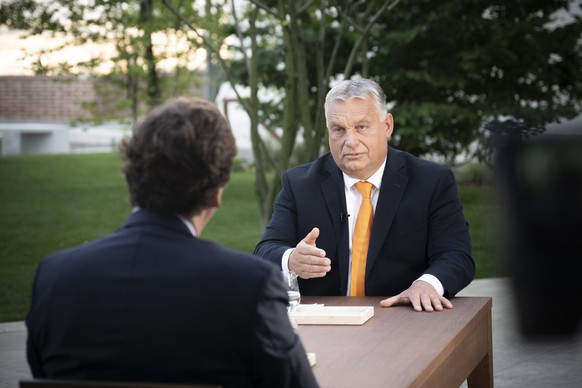 epa10828002 A handout photo made available by the Hungarian Prime Minister's press office.  Hungarian Prime Minister Viktor Orban gives an interview to American political commentator and media personality Tucker...