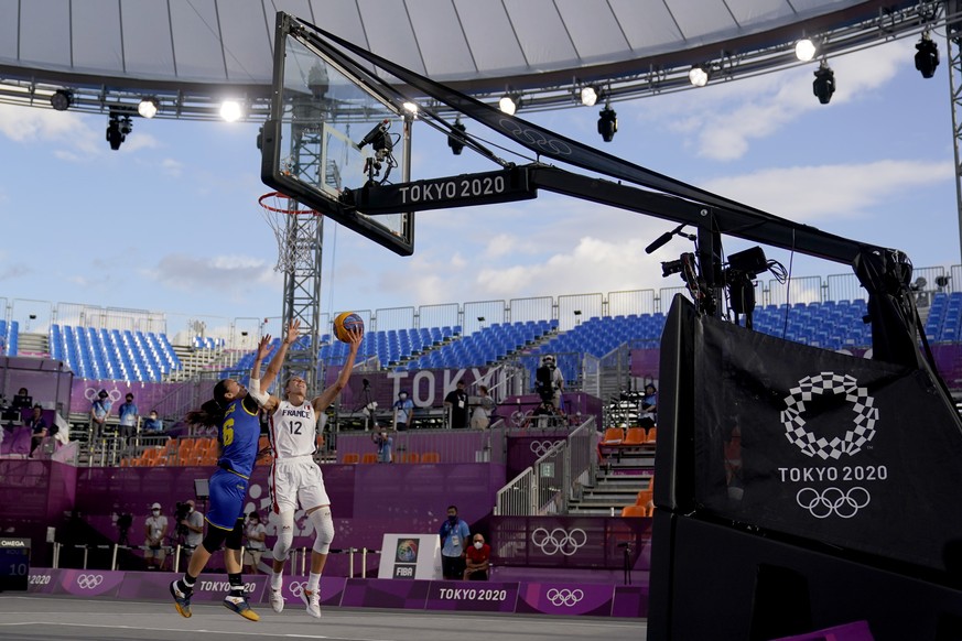 France&#039;s Laetitia Guapo (12) heads to the basket past Romania&#039;s Sonia Ursu (6) during a women&#039;s 3-on-3 basketball game at the 2020 Summer Olympics, Tuesday, July 27, 2021, in Tokyo, Jap ...