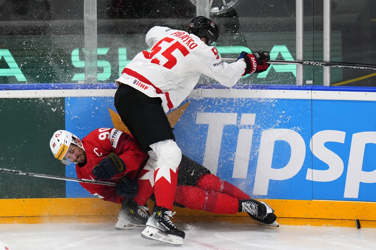 Canada's Colton Parayko, right, checks Switzerland's Roman Josi during the preliminary round match between Canada and Switzerland at the Ice Hockey World Championships in Prague, Czech Repub ...