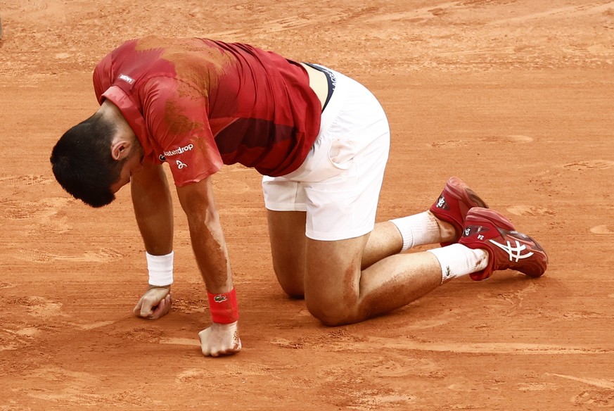 epa11388011 Novak Djokovic of Serbia falls during his men&#039;s singles Round of 16 match against Francisco Cerundolo of Argentina at the French Open Grand Slam tennis tournament at Roland Garros in  ...