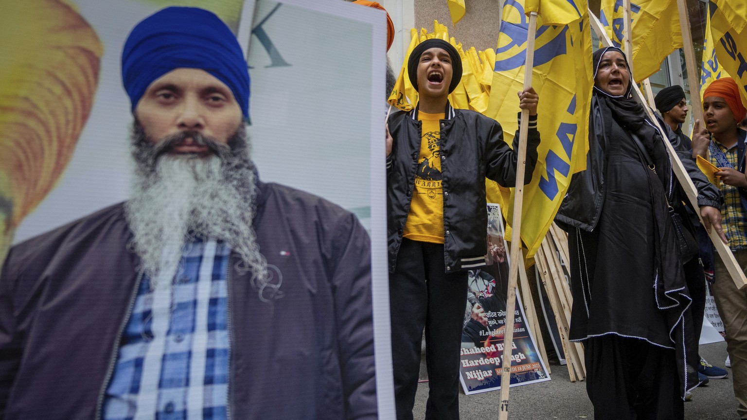 Protesters chant outside of the Consulate General of India office during a protest for the recent shooting of Shaheed Bhai Hardeep Singh Nijjar in Vancouver, British Columbia, Saturday, June 24, 2023. ...