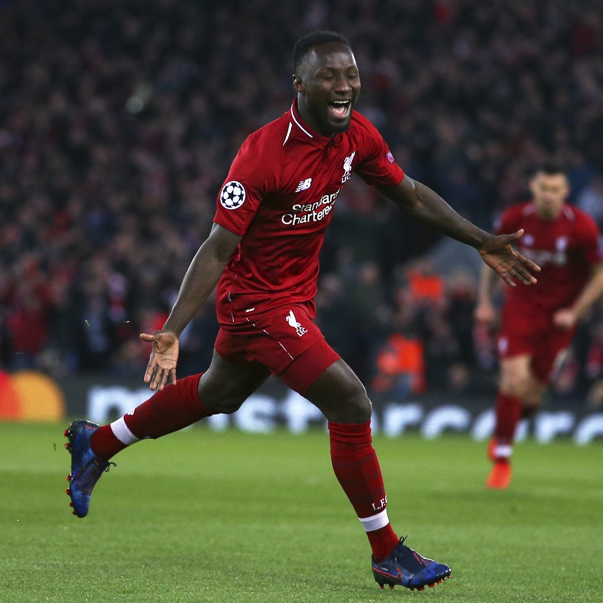 Liverpool's Naby Keita, center, celebrates after scoring the opening goal during the Champions League quarterfinal, first leg, soccer match between Liverpool and FC Porto at Anfield Stadium, Live ...
