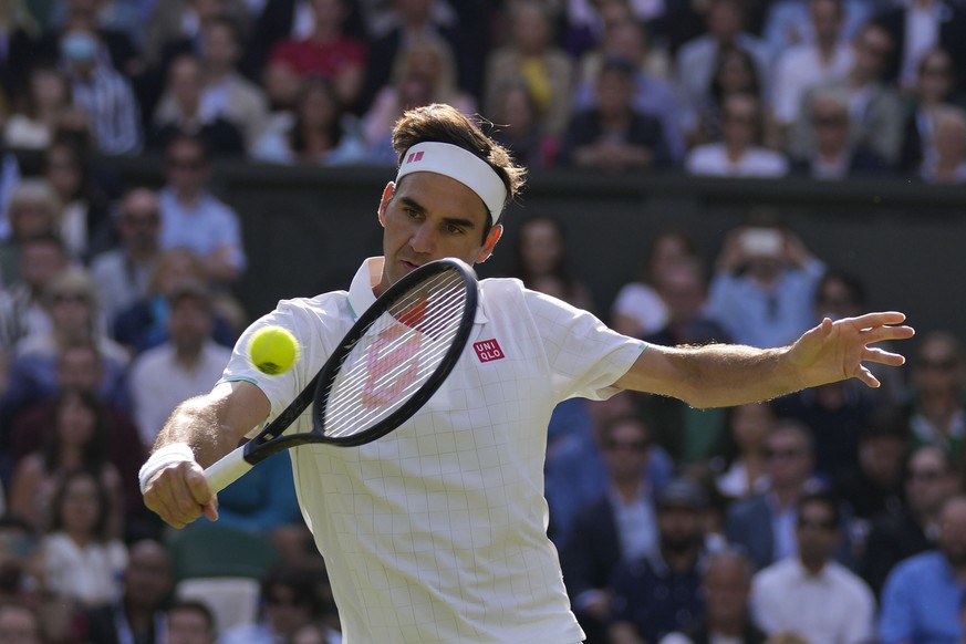 FILE - Switzerland&#039;s Roger Federer plays a return to Poland&#039;s Hubert Hurkacz during the men&#039;s singles quarterfinals match on day nine of the Wimbledon Tennis Championships in London, We ...