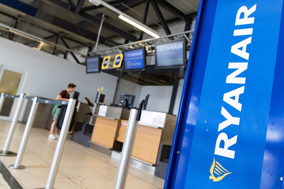 epa07012537 A man speaks to a ground crew at the check-in counters of Ryanair at the Schoenenfeld Airport in Berlin, Germany, 11 September 2018. Ryanair pilots and cabin crew in Germany will strike in ...