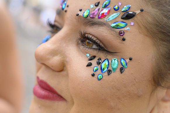 epa07765862 Participants arrive at a train station for the 28th Street Parade in Zurich, Switzerland, 10 August 2019. The Street Parade is an annual electronic dance music parade, in the city center a ...
