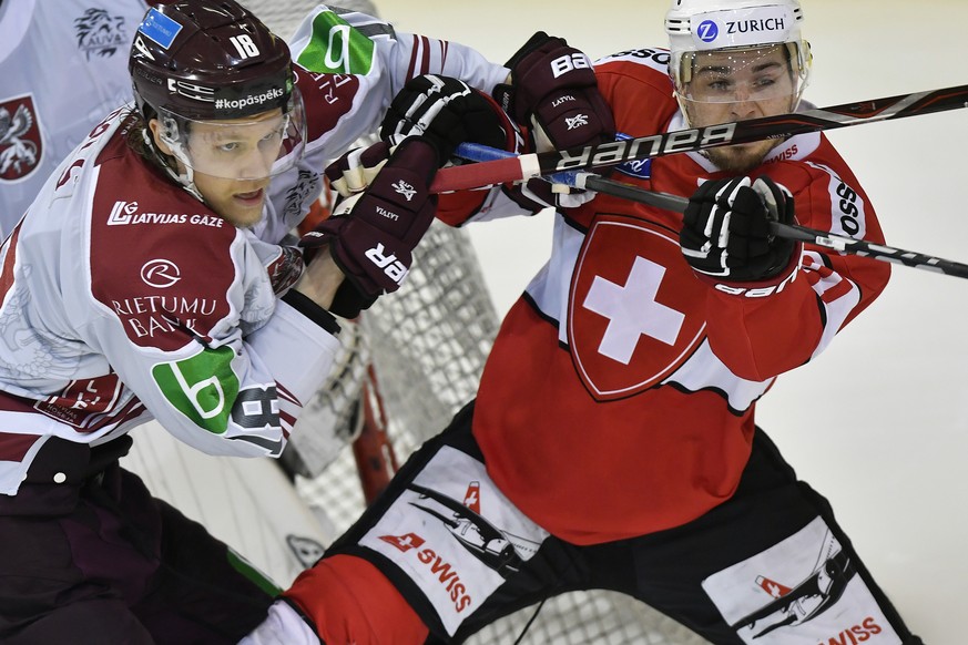 Swiss Marco Mueller, right, in action against Latvias&#039;s player Rodrigo Abols, left, during the friendly Ice Hockey match between Switzerland and Latvia in Herisau, Switzerland, 03, May 2019. (KEY ...