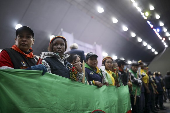 Attendees listen to a speech during a ceremony to formally begin a six-month cease-fire as part of a process to forge a permanent peace between the National Liberation Army or ELN and the government,  ...