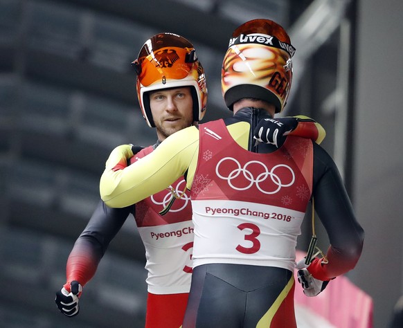 Tobias Arlt and Tobias Wendl of Germany hug in the finish area after their first run during the men&#039;s doubles luge final at the 2018 Winter Olympics in Pyeongchang, South Korea, Wednesday, Feb. 1 ...