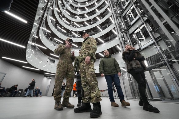 Visitors wearing military camouflage talk in the &#039;PMC Wagner Centre&#039;, which is associated with businessman and founder of the Wagner private military group Yevgeny Prigozhin, during the offi ...