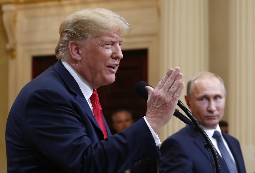 U.S. President Donald Trump speaks with Russian President Vladimir Putin during a press conference after their meeting at the Presidential Palace in Helsinki, Finland, Monday, July 16, 2018. (AP Photo ...