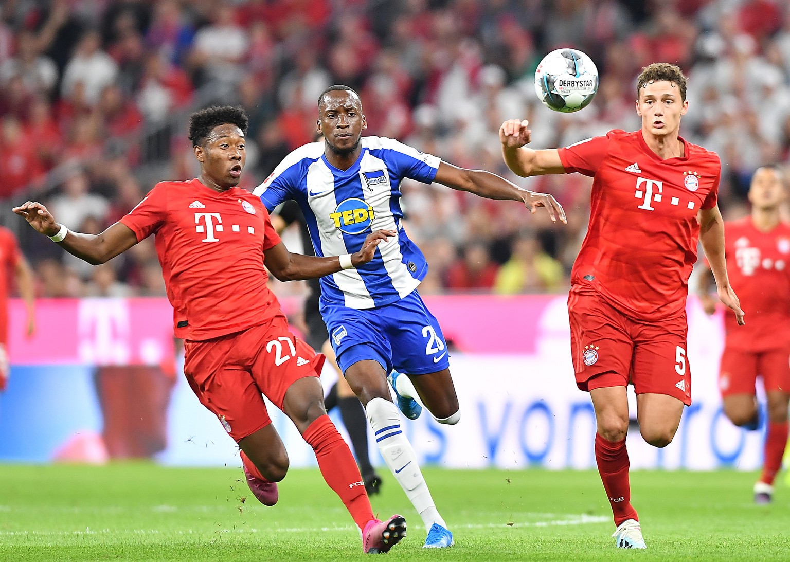 epa07776595 Bayern&#039;s David Alaba (L) and Bayern&#039;s Benjamin Pavard (R) in action against Hertha&#039;s Dodi Lukebakio during the German Bundesliga soccer match between FC Bayern and Hertha BS ...