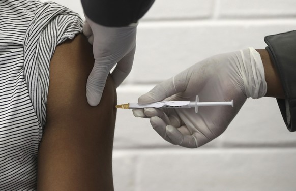 FILE - In this Wednesday, June 24, 2020 file photo, a volunteer receives an injection at the Chris Hani Baragwanath hospital in Soweto, Johannesburg, as part of Africa&#039;s first participation in a  ...