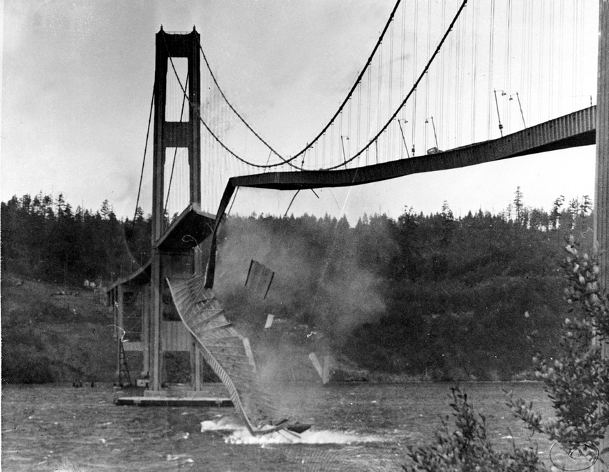 A large section of the concrete roadway in the center span of the new $6,400,000 Tacoma Narrows bridge crashes into the Puget Sound in Tacoma, Wa. on Nov. 7, 1940. High winds caused the bridge to sway ...