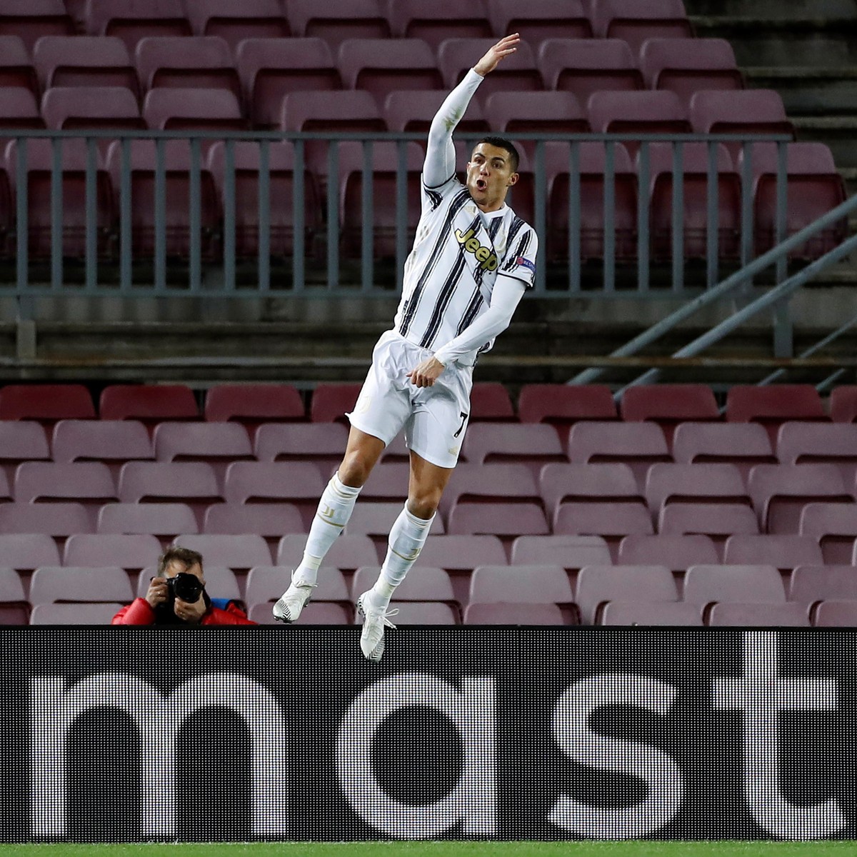 epa08871496 Juventus' striker Cristiano Ronaldo celebrates after scoring the 0-3 from the penalty during the UEFA Champions League group G between FC Barcelona and Juventus at Camp Nou stadium in ...