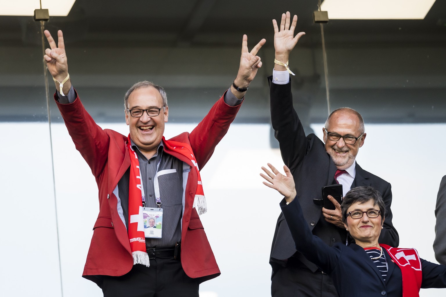 Switzerland&#039;s Defence Minister Guy Parmelin, left, reacts with his wife Caroline, right, and Peter Gillieron, President of the Swiss Football Association SFV, back right, during the FIFA World Cu ...