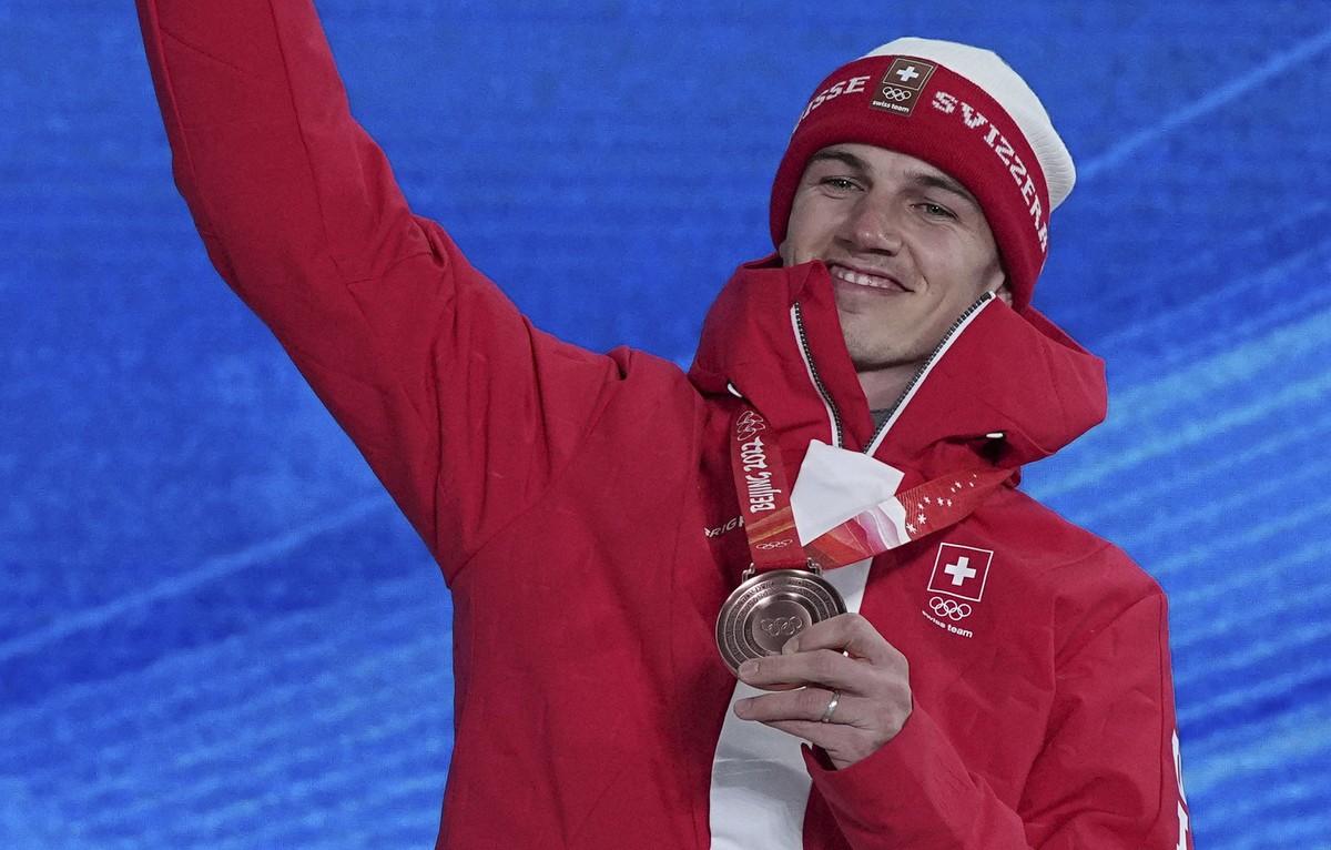 Bronze medalist Switzerland's Jan Scherrer celebrates during a medal ceremony for the men's halfpipe at the 2022 Winter Olympics, Friday, Feb. 11, 2022, in Zhangjiakou, China. (AP Photo/Greg ...