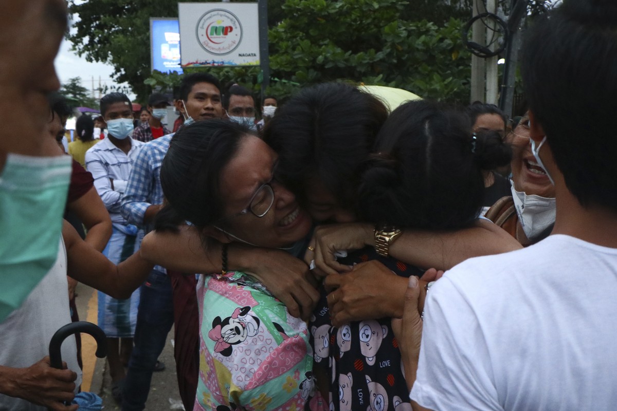 A man is hugged by two women after being released from Insein Prison in Yangon, Myanmar, Wednesday, June 30, 2021. Myanmar's government began releasing about 2,300 prisoners on Wednesday, includi ...