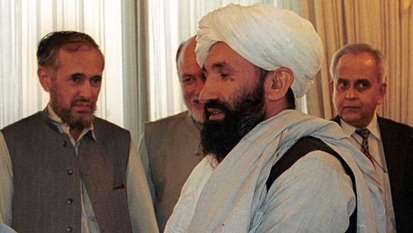 FILE - In this Aug. 25, 1999 file photo, Mullah Hasan Akhund, right, then Afghanistan's Foreign Minister is received by then Pakistan Prime Minister Nawaz Sharif, in Islamabad. The Taliban on Tue ...