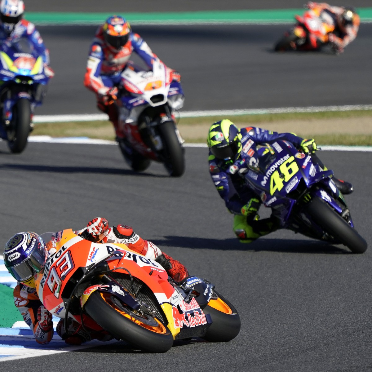 Spain's rider Marc Marquez (93) steers his Honda tailed by Italy's Valentino Rossi of Yamaha during the MotoGP Japanese Motorcycle Grand Prix at the Twin Ring Motegi circuit in Motegi, north ...