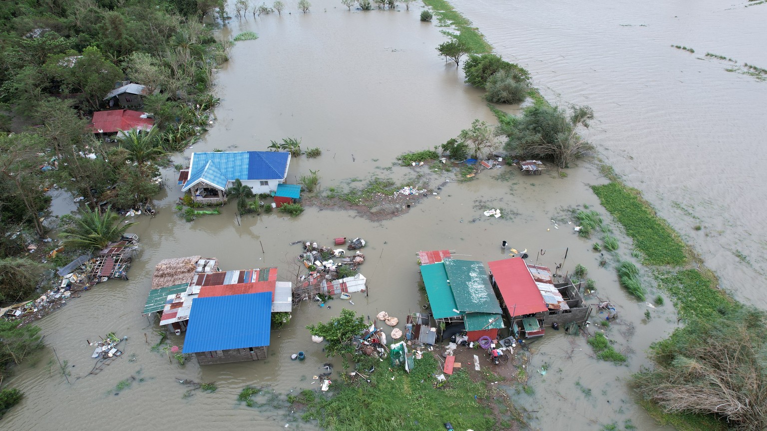 epaselect epa12399274 An aerial drone photo shows flooded homes in the typhoon-hit town of Burgos, Ilocos Norte province, Philippines, 23 September 2025. The Philippine weather service said Super Typh ...