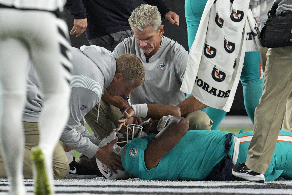 FILE - Miami Dolphins quarterback Tua Tagovailoa is examined during the first half of the team's NFL football game against the Cincinnati Bengals, Thursday, Sept. 29, 2022, in Cincinnati. This se ...