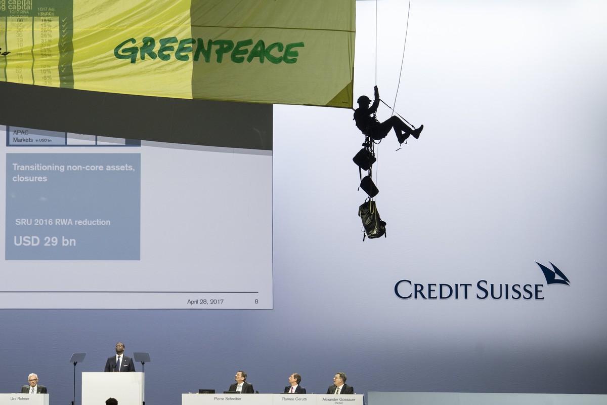 epa05932367 A Greenpeace activist abseils from the ceiling during the Credit Suisse (CS) general assembly in protest against the bank's pipline deals, at the Hallenstadion in Zurich, Switzerland, ...
