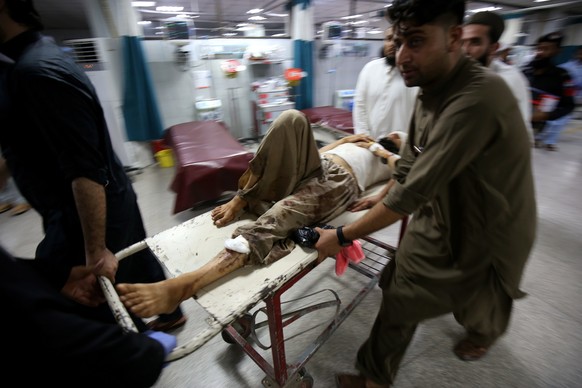 epa10777740 An injured man is shifted to a hospital following a blast targeting a gathering of Islamic political party Jamiat Ulma-e-Islam (JUI-F), in Peshawar, Pakistan, 30 July 2023. At least 40 peo ...
