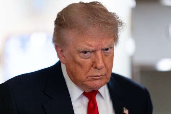 FILE - President Donald Trump speaks with reporters while on Air Force One en route to Oakland County International Airport, July 27, 2026, in Waterford Township, Mich. (AP Photo/Alex Brandon, File)
D ...