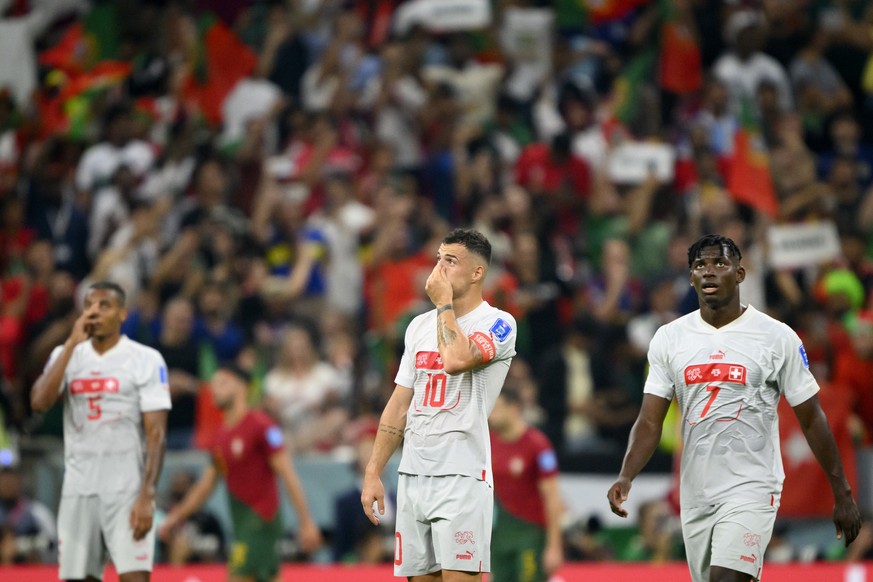 Switzerland&#039;s defender Manuel Akanji, Switzerland&#039;s midfielder Granit Xhaka and Switzerland&#039;s forward Breel Embolo, react after the Portugal&#039;s second goal during the FIFA World Cup ...