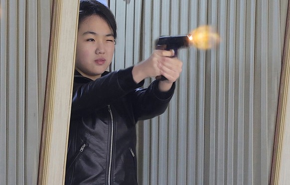 epaselect epa12813262 A photo released by the official North Korean Central News Agency (KCNA) shows North Korean leader Kim Jong Un's daughter Kim Ju Ae (C) test firing a new-type pistol during  ...