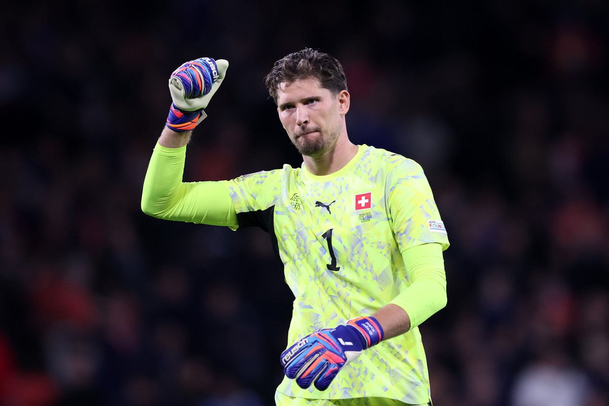 Switzerland goalkeeper Gregor Kobel celebrates after teammate Zeki Amdouni scored their side's third goal during the Nations League soccer match between Scotland and Switzerland in Glasgow, Scotl ...