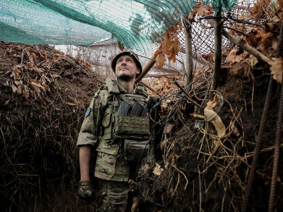 epa10961030 Call-sign Jimmy, commander of a unit of the 24-th Mechanized Brigade moves through a trench in the Donetsk region, Ukraine, 06 November 2023. Commander Jimmy is an economist. Before the Ru ...
