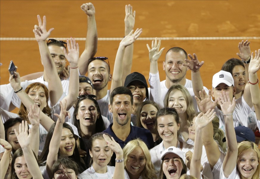 epa08767176 YEARENDER 2020 .SPORTS..Novak Djokovic of Serbia (C) poses for a photo with volunteers at the Adria Tour tennis tournament in Belgrade, Serbia, 14 June 2020. EPA/Andrej Cukic