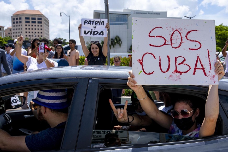 People protest during a demonstration in solidarity with thousands of Cubans who took to the streets Sunday, July 11, 2021, in various locations in Cuba, in one of the largest protests to take place o ...