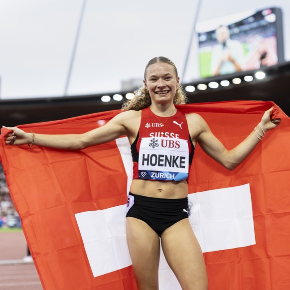 Fabienne Hoenke of Switzerland celebrates with a Swiss flag after winning the 200 meters women, during the World Athletics Diamond League Weltklasse Zurich athletics meeting at the Letzigrund stadium  ...