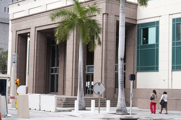 Pedestrians approach the U.S. Courthouse, Tuesday, Jan. 4, 2022, in Miami. The U.S. government announced Tuesday that it charged Mario Antonio Palacios Palacios, a 43-year-old former Colombian soldier ...