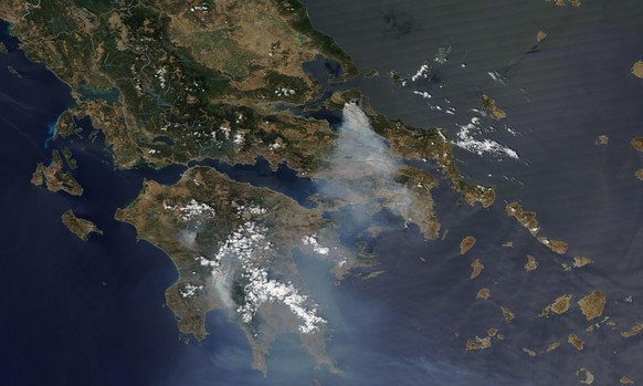 In this satellite image provided by Maxar Technologies wildfires burn north of Athens, Greece on the island of Evia, where some of the most destructive and active fires continue to burn, Sunday, Aug.  ...